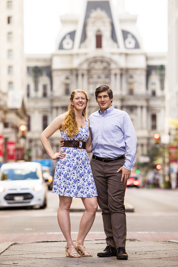 traditional portrait of the couple as they stand side by side with their arms around one another smiling at the camera during their philly engagement session 