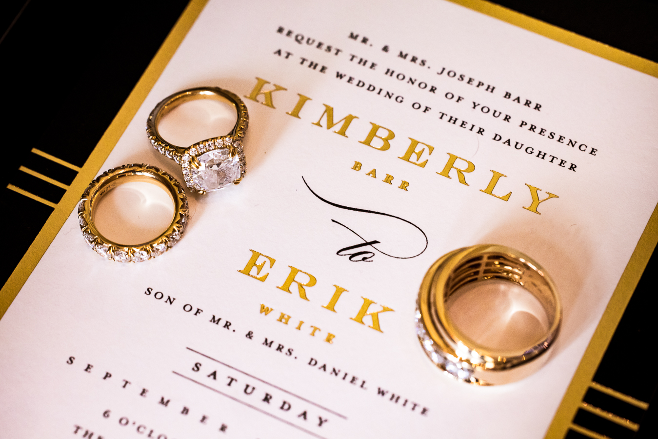 palace at somerset park wedding photographer, lisa rhinehart, captures this unique black and gold wedding theme when detail photos are taken of the couples gold rings with their black and gold invitation 