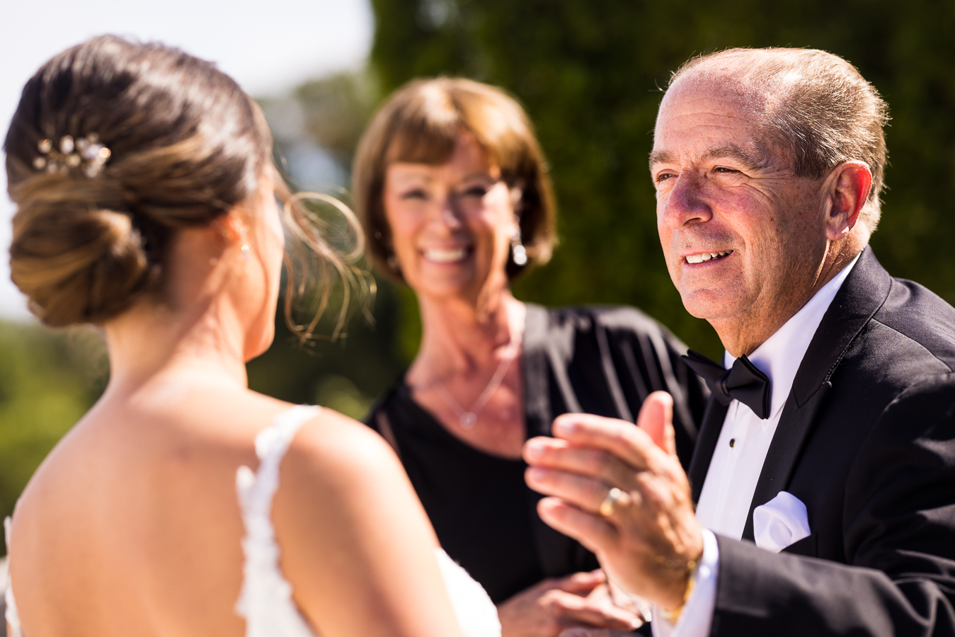 creative nj wedding photographer, rhinehart photography, captures this intimate and sentimental first look outside of the palace at somerset park in NJ as the father and mother of the bride smile at her in awe after seeing her for the first time as a bride 