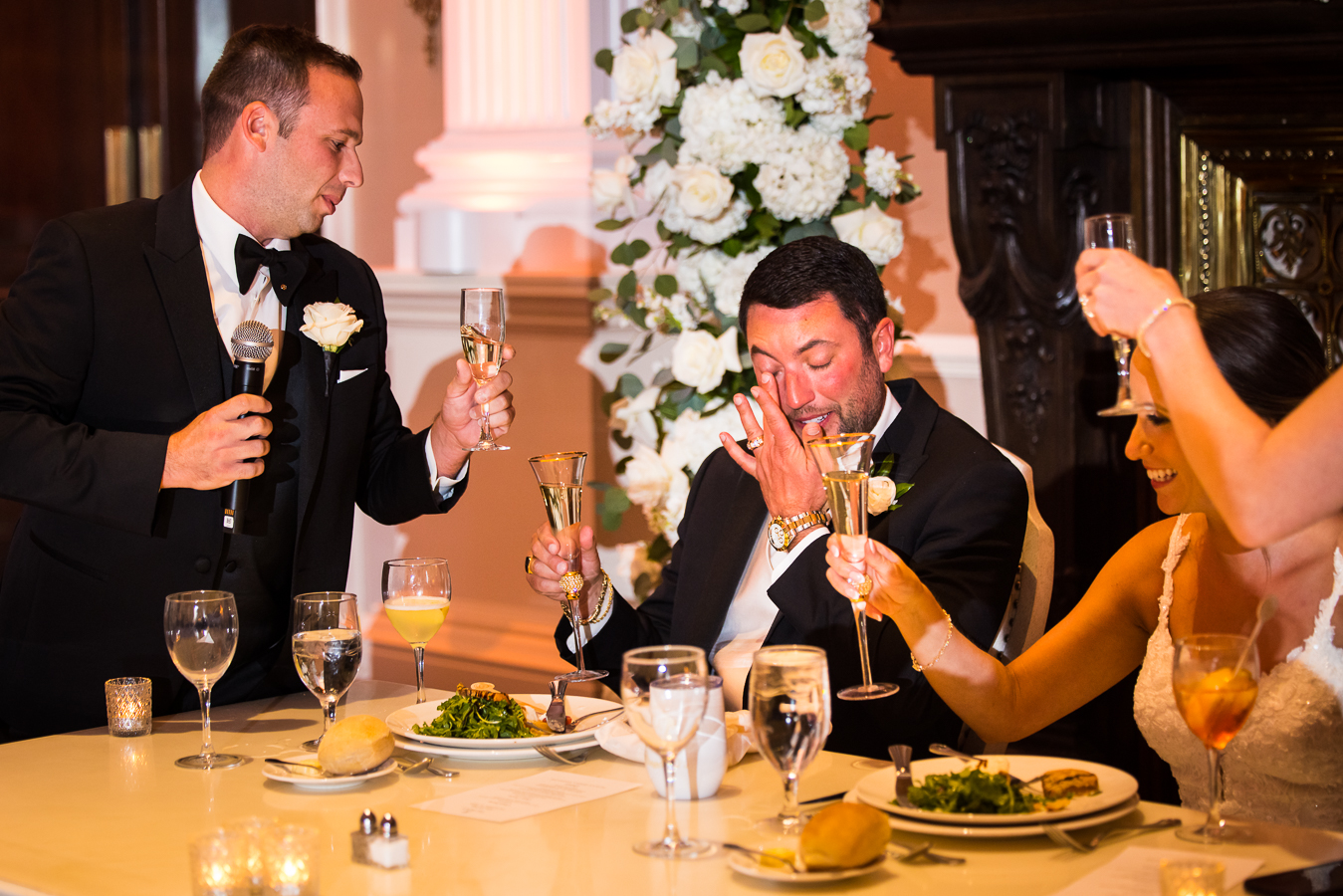 nj wedding photographer, lisa rhinehart, captures this sentimental moment of the groom as he wipes away his tears from the heartfelt speeches given during this palace at somerset wedding reception 