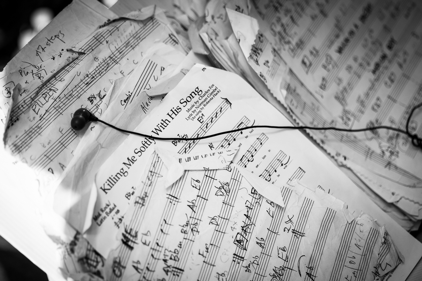 black and white image of music sheets with handwritten notes on them 