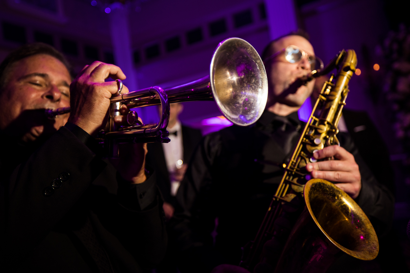 creative nj wedding photographer, lisa rhinehart, captures this close up creative image of the craig scott band as they play their instruments during this black and gold wedding reception at the palace at somerset park 