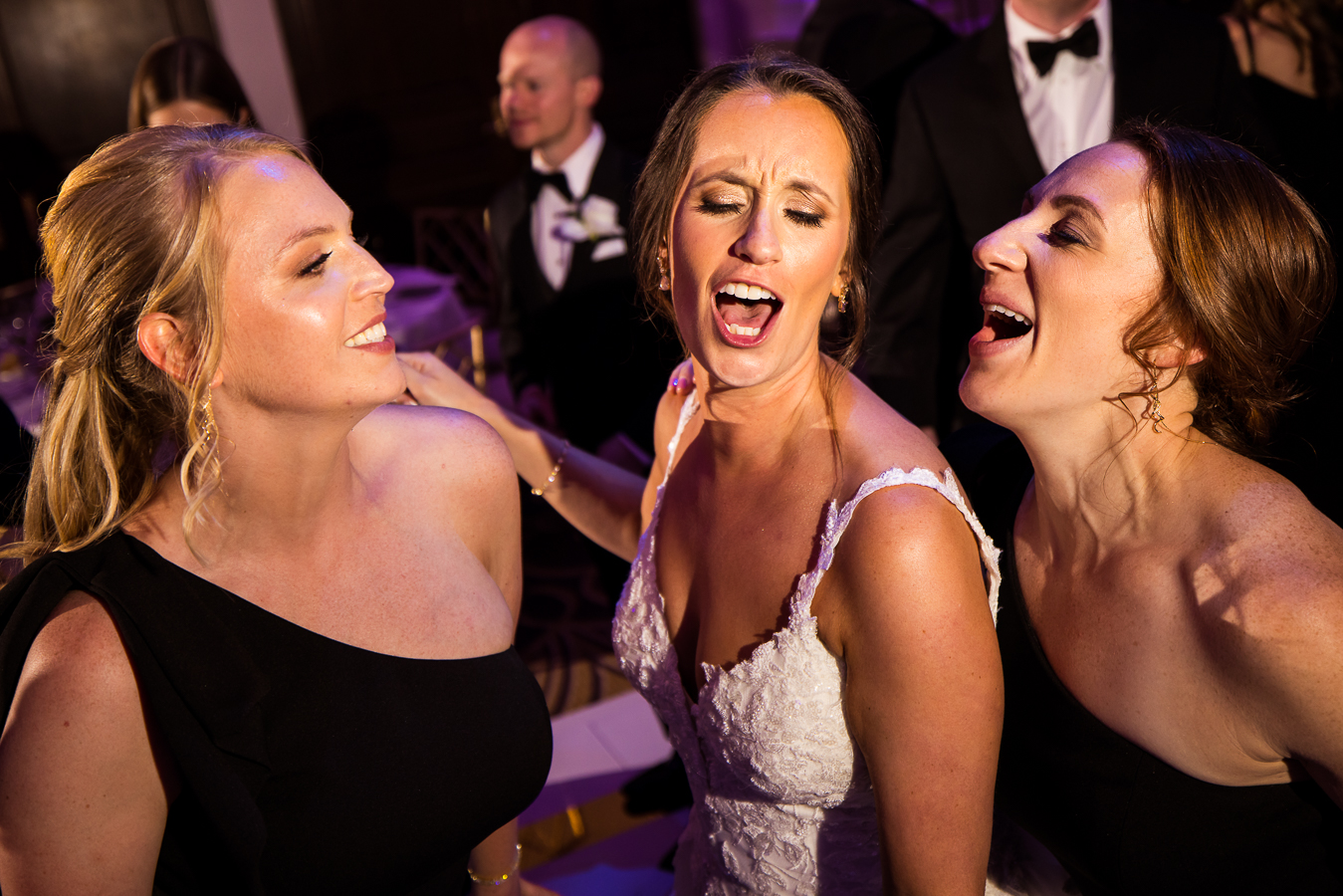 nj wedding photographer, lisa rhinehart, captures this fun candid moment from the wedding reception of the bride singing with her bridesmaids at the palace in somerset nj 
