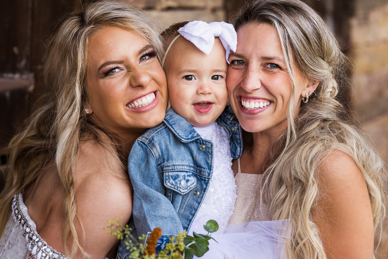 pa wedding photographer, lisa rhinehart, captures this close up portrait of the bride with the flower girl and a bridesmaid before her country barn wedding in halifax pa 