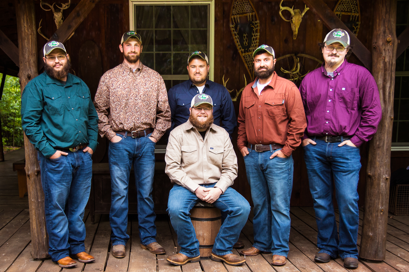 pa wedding photographer, lisa rhinehart, captures this portrait of the groom and his groomsmen dressed in all different colored button-down shirts, jeans and their boots during this country inspired wedding 