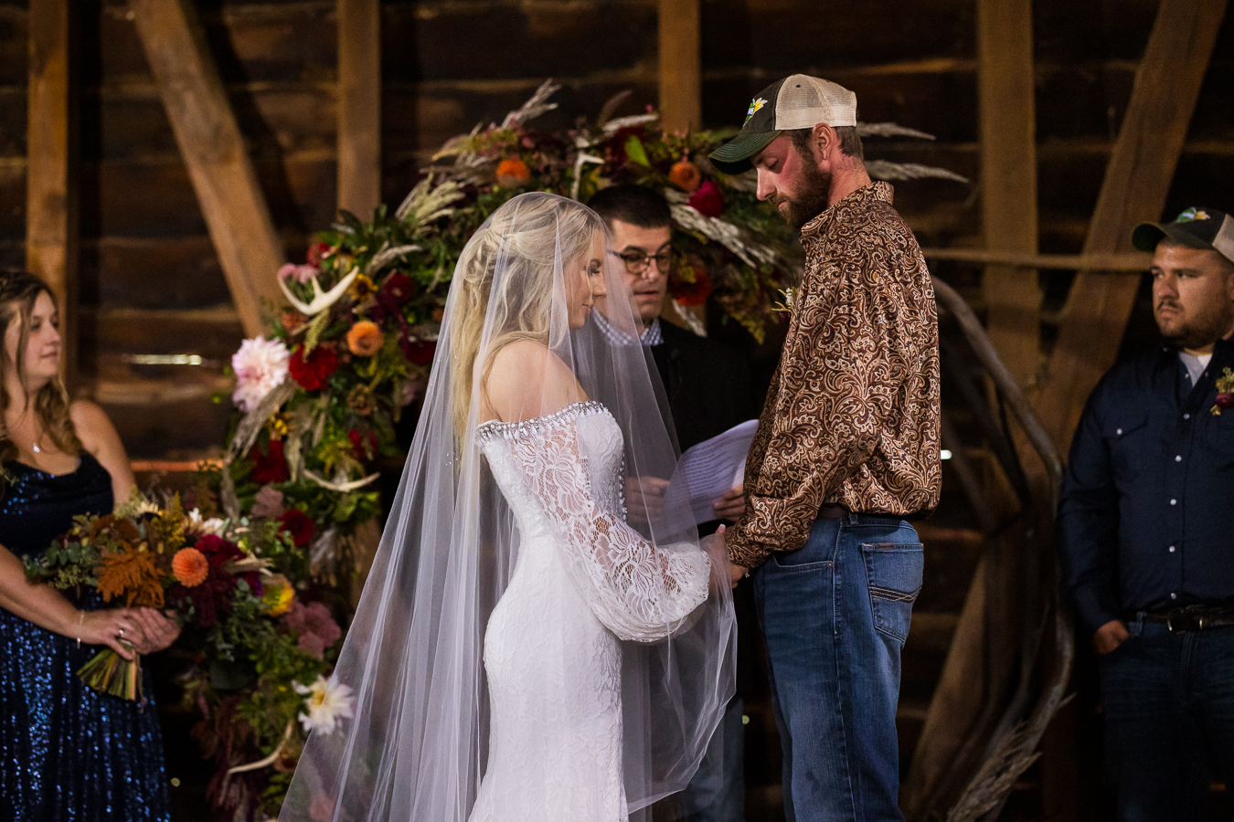 best pa country wedding photographer, lisa rhinehart, captures this sentimental moment between the bride and groom as they hold hands and share a pray together during their barn wedding ceremony in halifax pa 