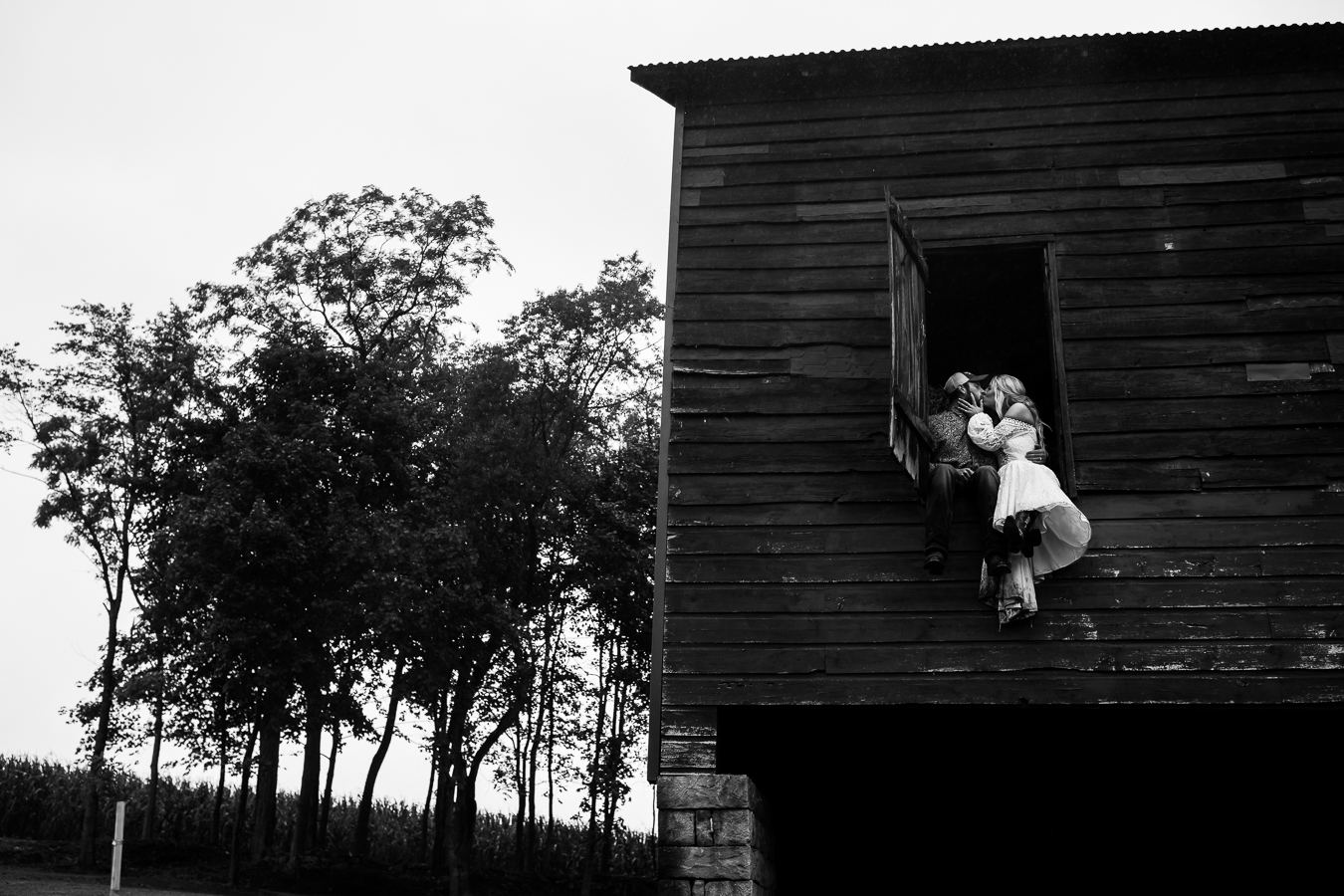 best pa wedding photographer, lisa rhinehart, captures this fun, unique, creative image of the bride and groom as they kiss in the hayloft of the barn during this country wedding
