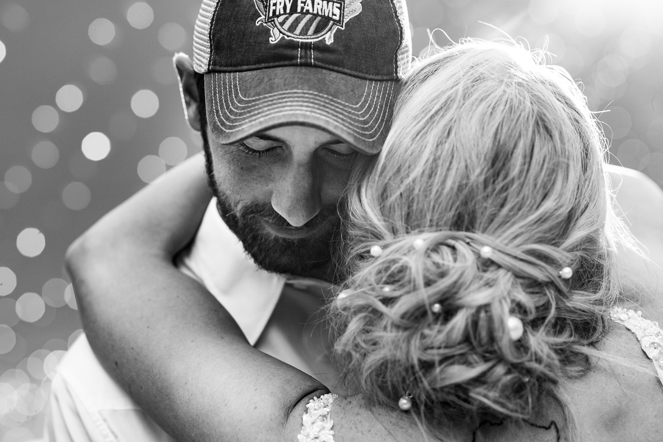 best creative pa wedding photographer, lisa rhinehart, captures this black and white close up image of the bride and groom as they share their first dance together during their country inspired wedding reception in halifax pa 