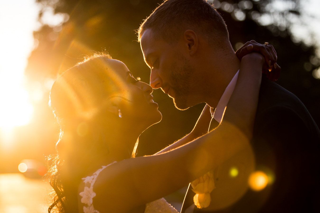 Image of the groom as he looks into his Ethiopian bride's eyes during golden hour in downtown DC at St Francis Hall during their Multicultural DC Wedding reception captured by dc wedding photographer, Lisa Rhinehart