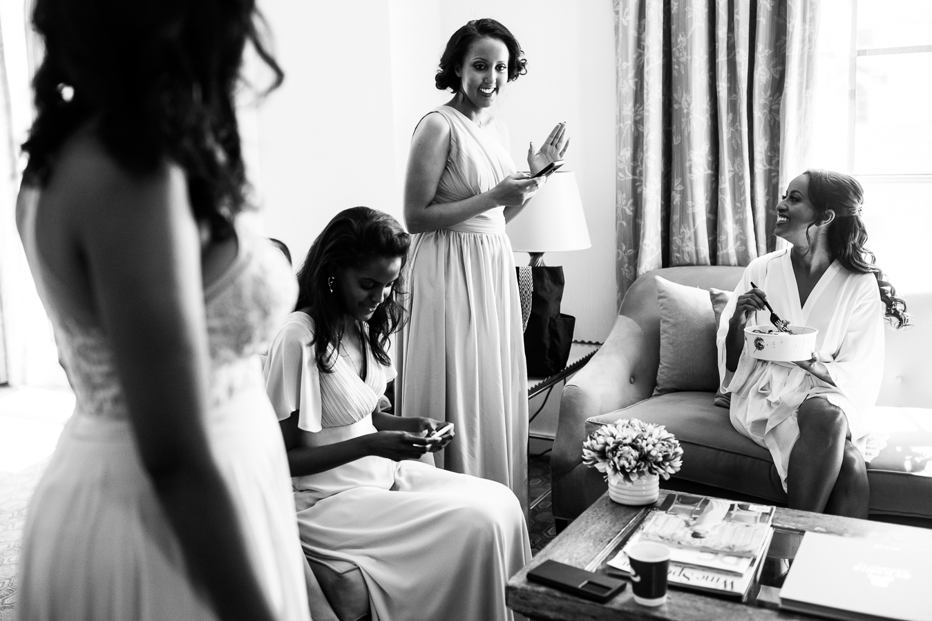 dc wedding photojournalist, Lisa Rhinehart, captures this black and white image of the Ethiopian bride and her bridesmaids as they get ready together at the st regis hotel inn Washington DC
