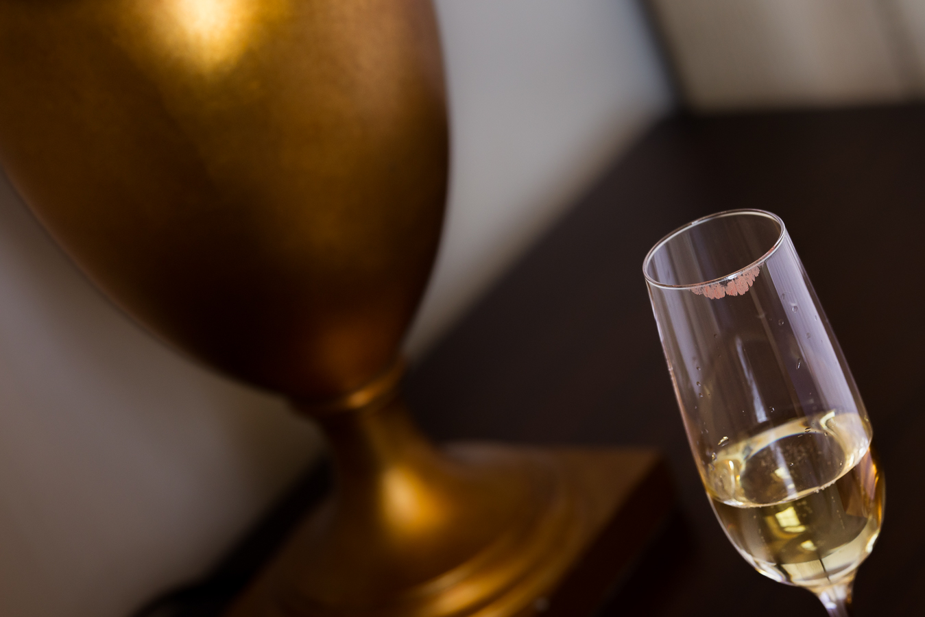 close up image of a glass of champagne with a lipstick mark on it inside of the st regis hotel during wedding preparations