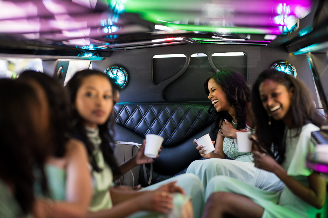 fun wedding photographer, Lisa Rhinehart, captures this vibrant fun image of the bridesmaids as they ride in the limo through downtown dc as they head to st Francis hall for the wedding ceremony 