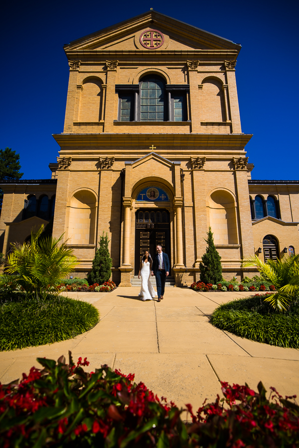 dc wedding photographer, Lisa Rhinehart, captures this unique image of the Ethiopian bride and groom as they walk hand in hand in the Spanish gardens at st francis hall for their first look before their Multicultural DC Wedding