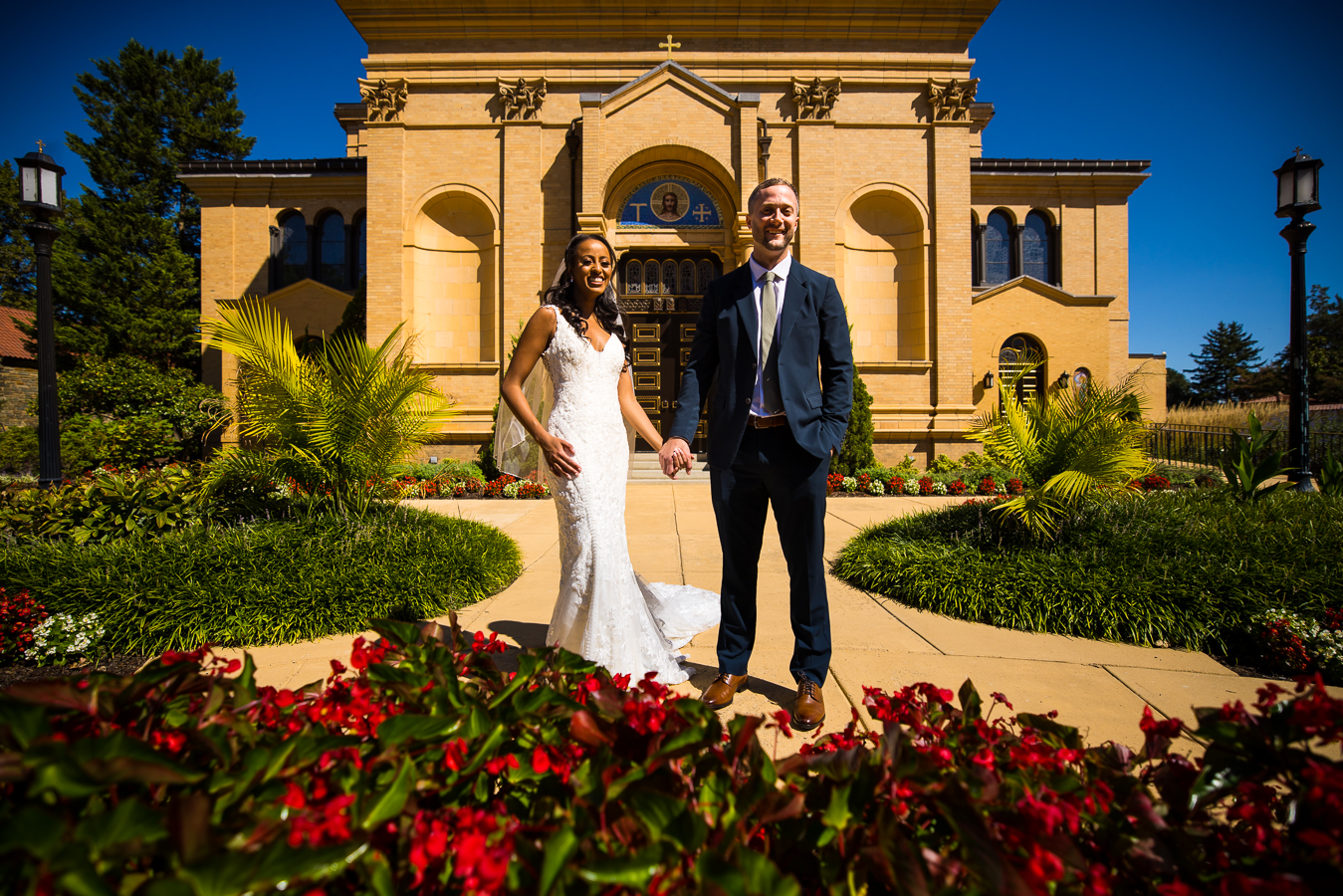 Multicultural DC Wedding photographer, Lisa Rhinehart, captures this image of the groom and his Ethiopian bride as they hold hands in the Spanish gardens of st Francis hall during their first look before their wedding ceremony 