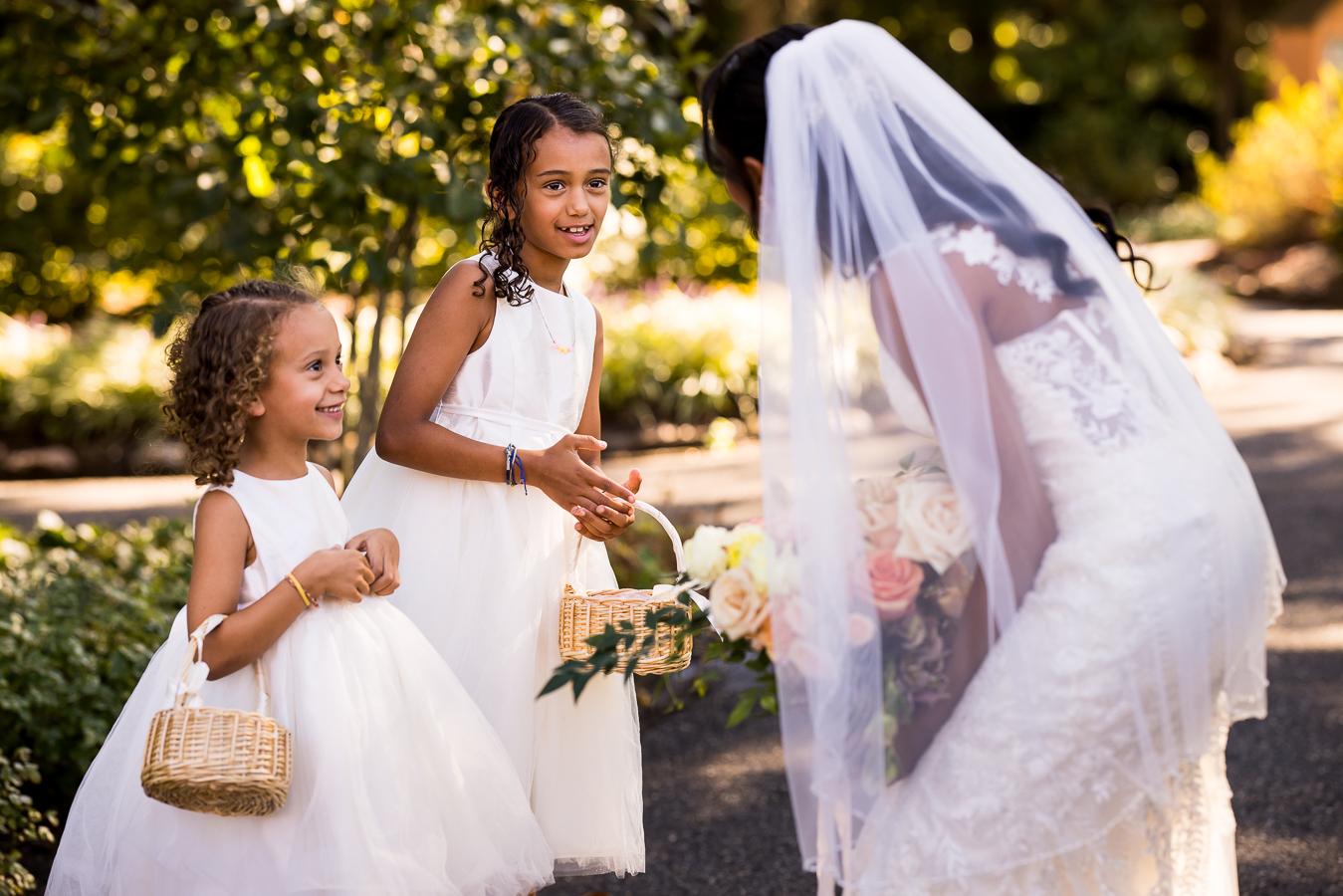 candid moment between the bride and her flower girls before the wedding ceremony at st francis hall captured by dc wedding photographer, Lisa Rhinehart 