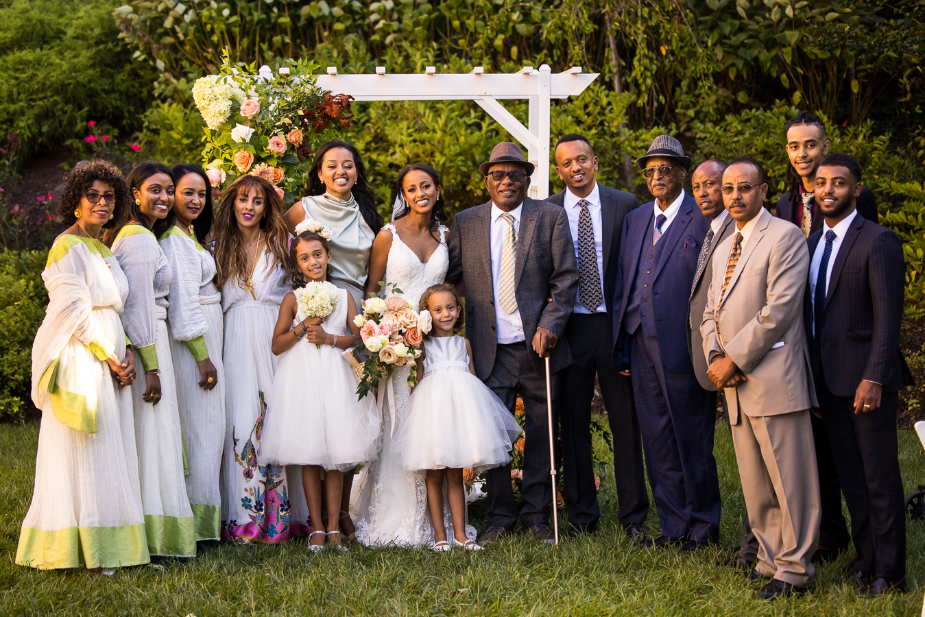 traditional family portrait of the bride and her large Ethiopian family after this outdoor wedding ceremony at st francis hall in dc 