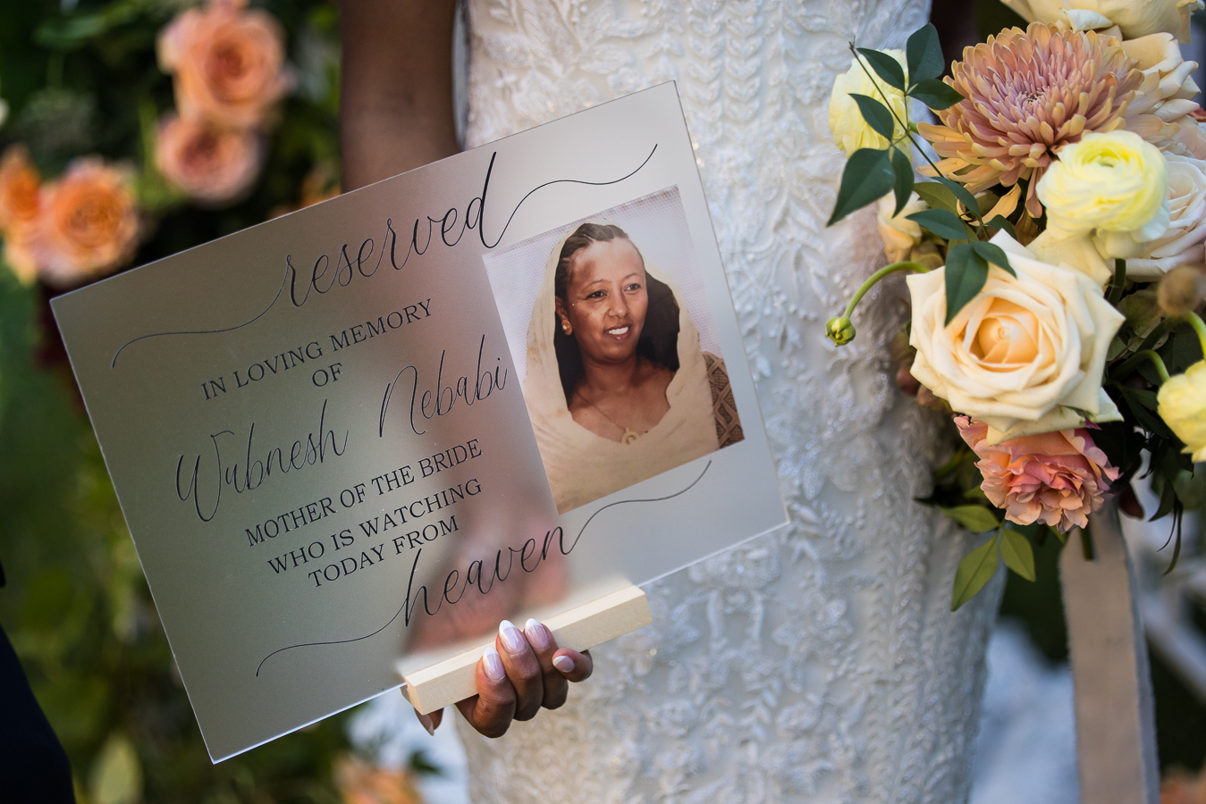 dc wedding photographer, Lisa rhinehart, captures this sentimental image of the bride as she holds the reserved sign in memory of her mom who passed away before her Multicultural DC Wedding at st francis hall 