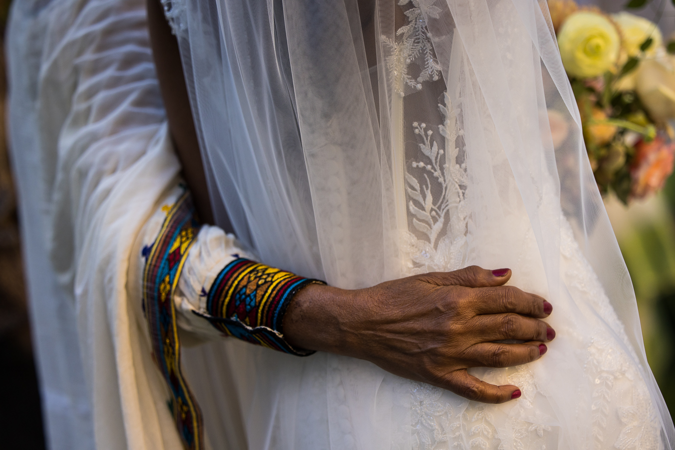 close up image of the bride as she hugs her Ethiopian family after her Multicultural DC Wedding ceremony at st francis hall 