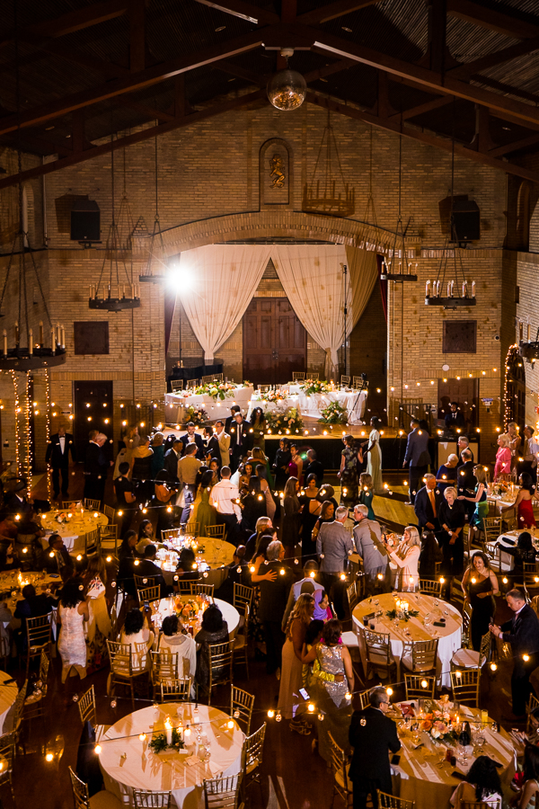 st francis wedding photographer, lisa rhinehart, captures this aerial shot of this multicultural wedding reception inside of st francis hall in Washington dc