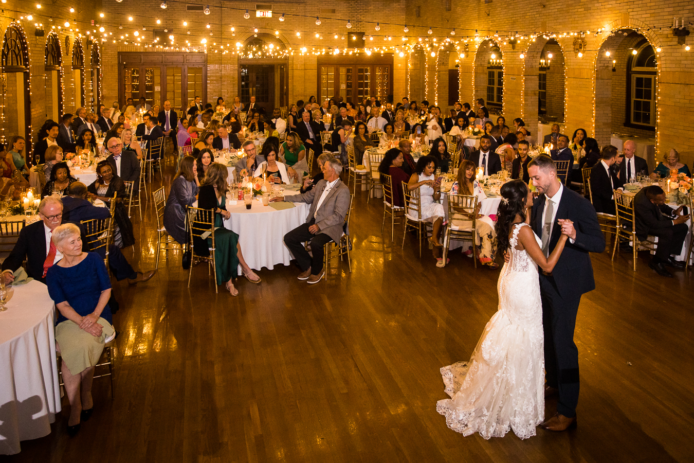dc wedding photographer, lisa rhinehart, captures this image of the groom and his ethiopian bride as they share their first dance together during their multicultural st francis hall wedding reception in dc 