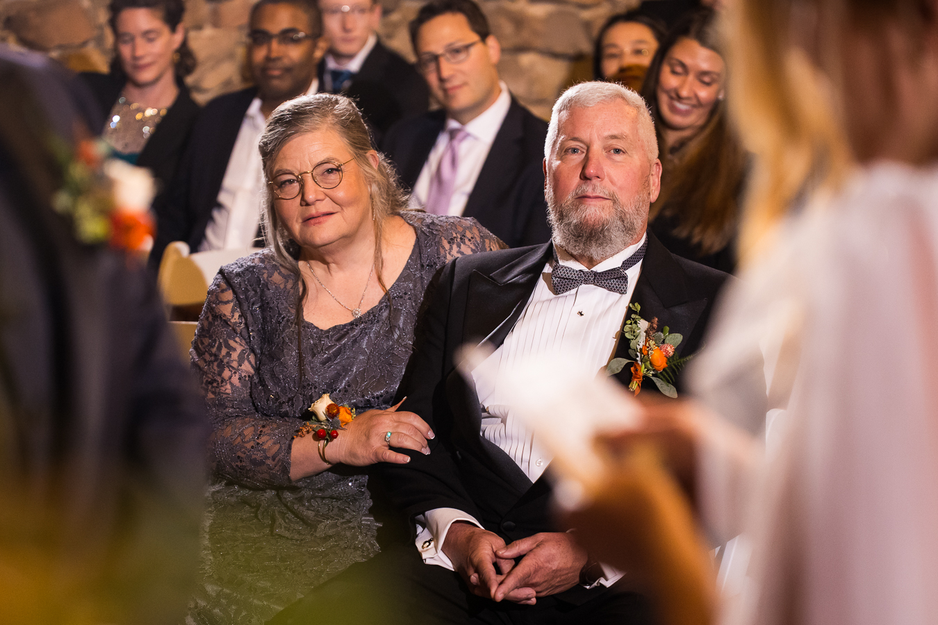 candid moment of the parents of the groom and guests as they watch and listen during this wedding ceremony in Lancaster pa 
