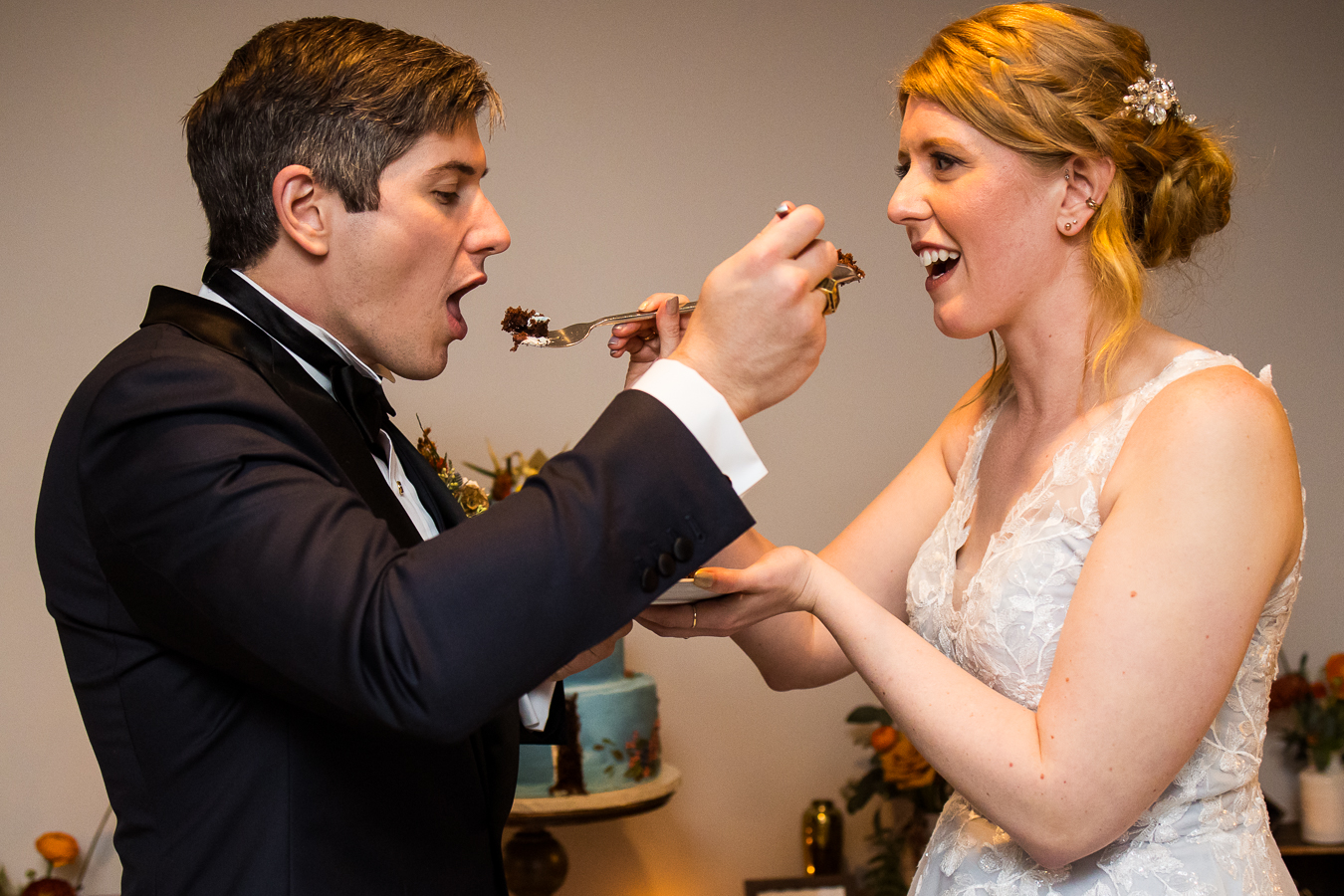 pa wedding photographer, lisa rhinehart, captures this moment between the bride and groom as they share cake with one another during their wedding reception at Elizabeth furnace in lititz pa
