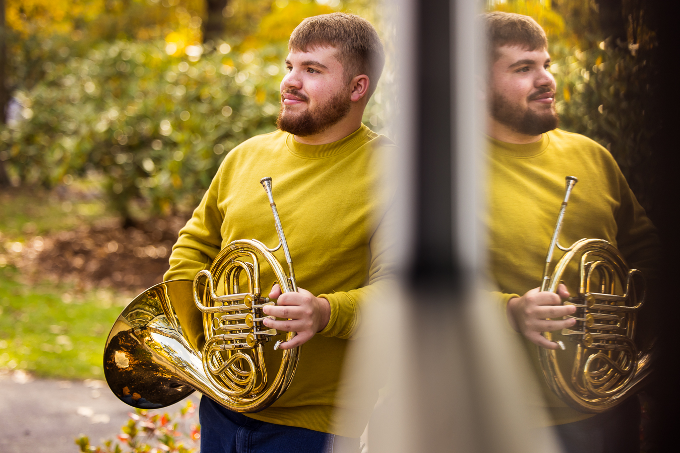 Northern York senior portrait photographer, lisa rhinehart, captures this creative, unique, reflective image of his cerebral palsy senior as he shows off his french horn at kings gap mansion in central pa 