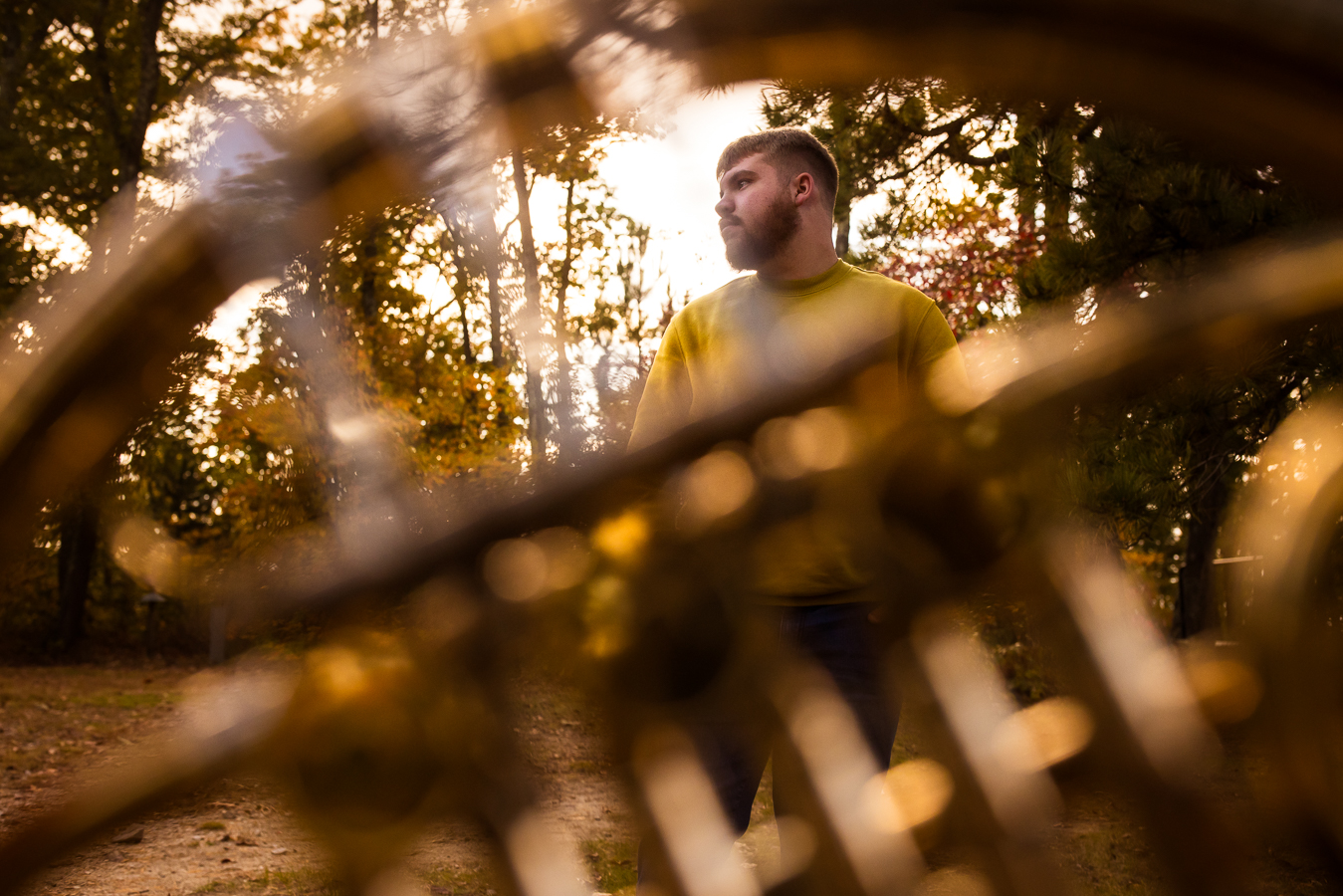 northern york senior portrait photographer, lisa rhinehart, captures this creative, unique image of this senior with cerebral palsy through his french horn as he is surrounded by the fall foliage of kings gap mansion in central pa 