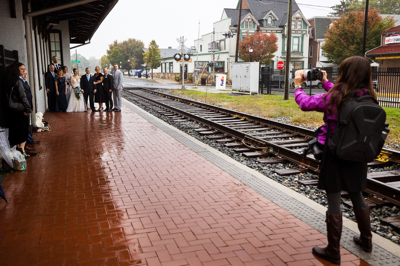 behind the scenes image of wedding photographer, lisa rhinehart, as she takes family portraits at lincoln railroad station in pa 