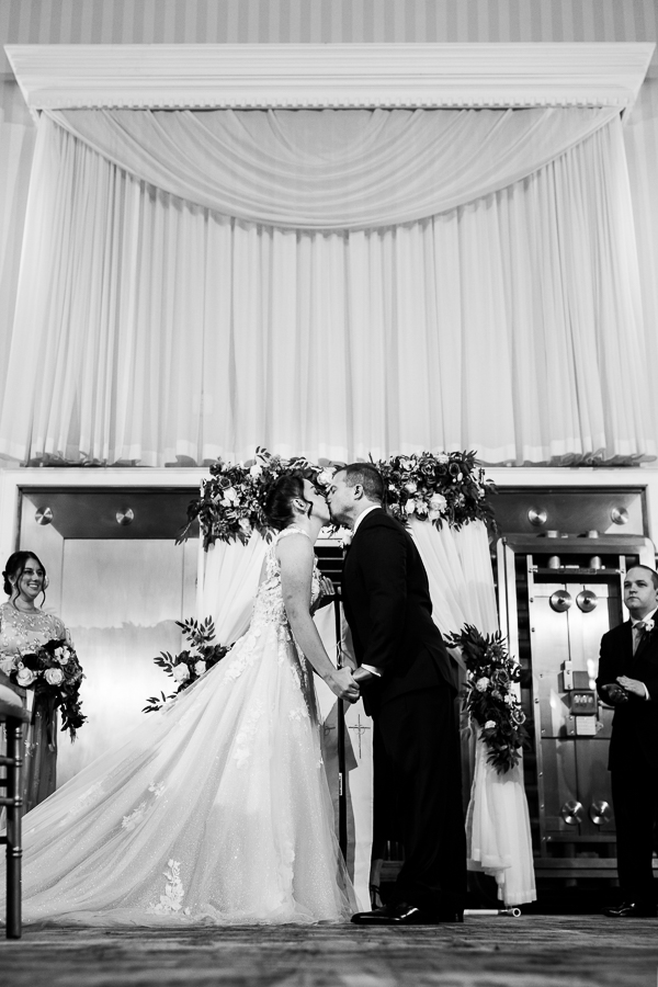 black and white image of the bride and groom as they kiss one another inside of this historic wedding venue captured by Gettysburg wedding photographer, rhinehart photography
