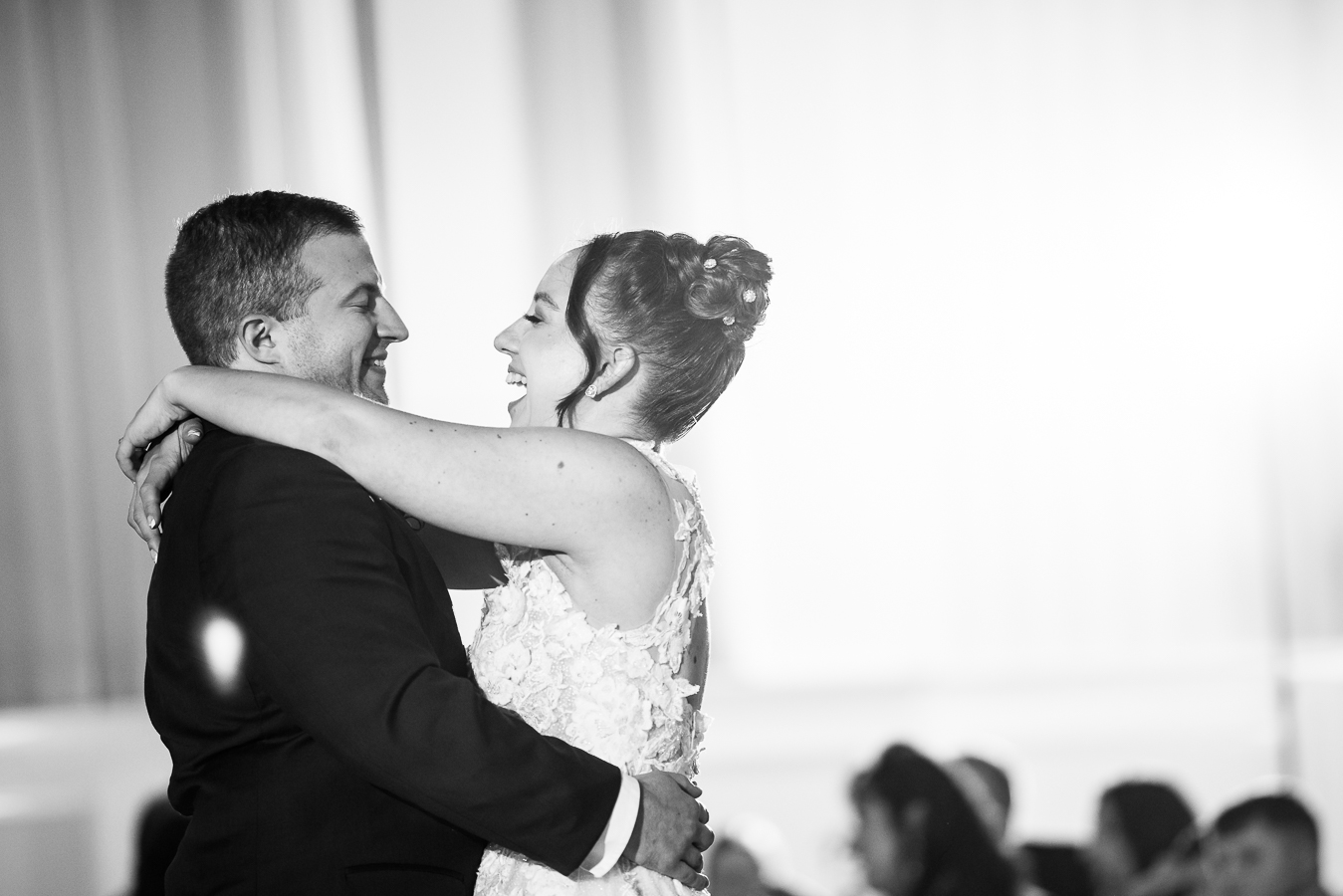 black and white image of the bride and groom as they smile and sing to one another during their first dance at their historic wedding venue in central pa wedding reception 