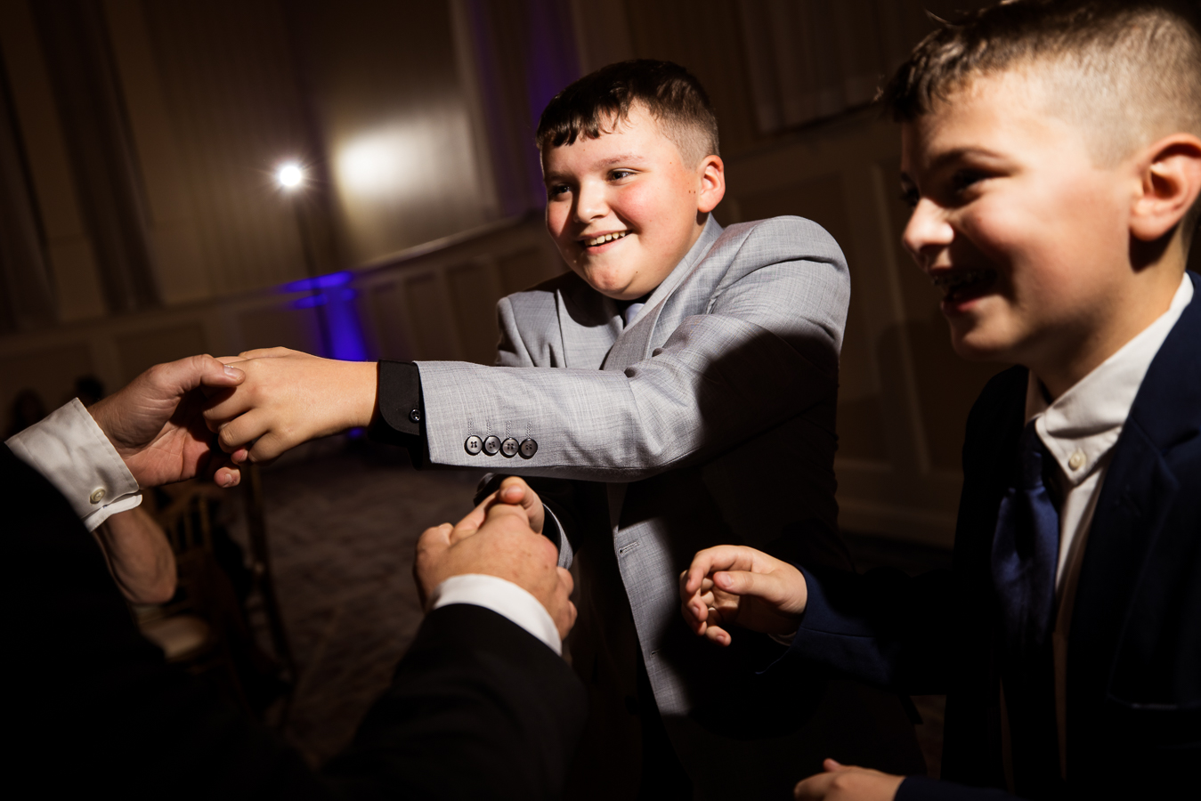 image of kids as they dance and goof off during this indoor wedding reception 