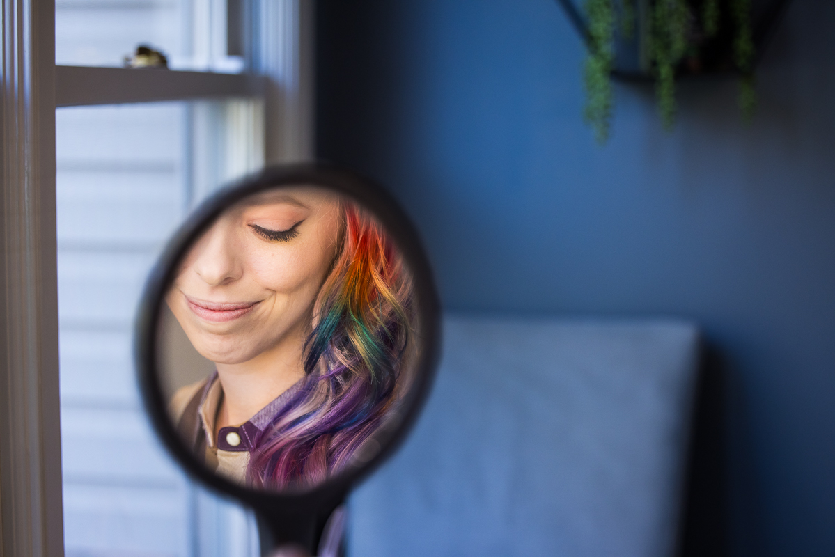 bridal portrait wedding photographer, lisa rhinehart, captures this creative, unique image of the bride looking at herself in a mirror with her rainbow hair before her wedding at Murray hill in virginia
