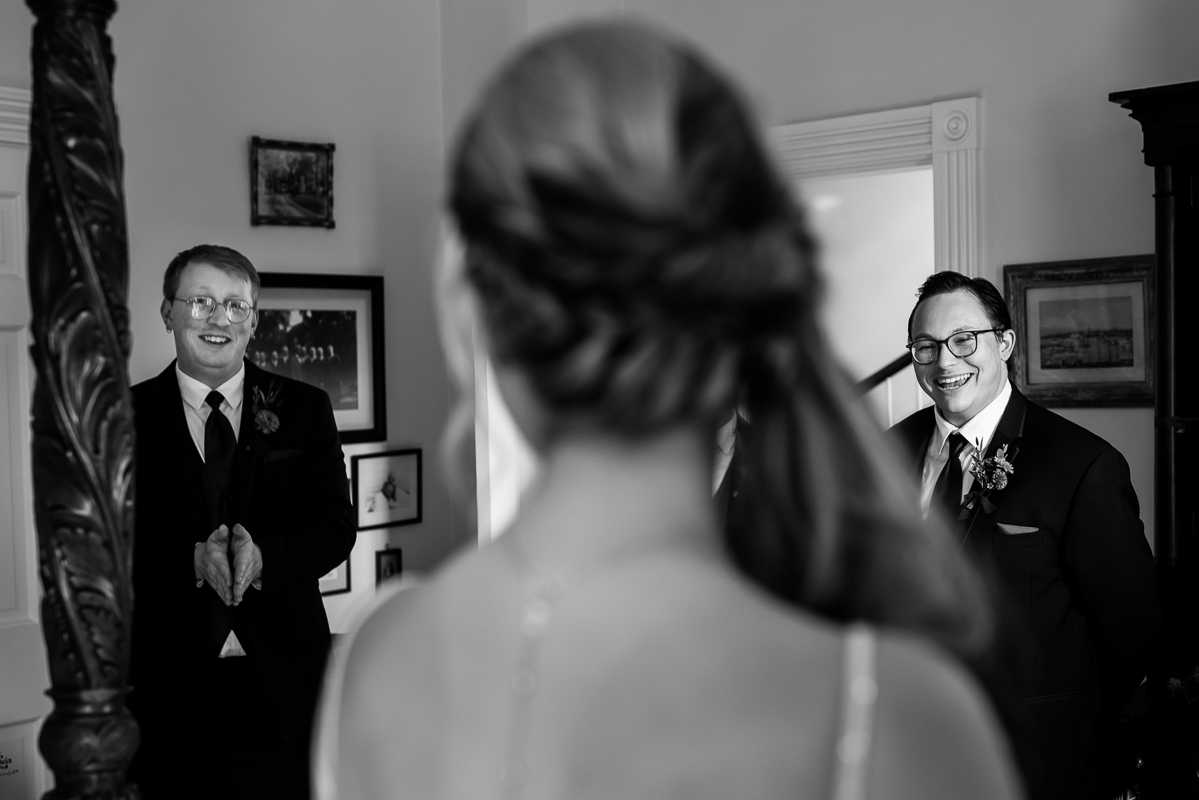 black and white image of the bride as she does a first look with her wedding party before her outdoor wedding ceremony in Leesburg va