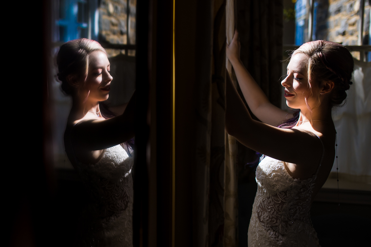virginia wedding photographer, lisa rhinehart, captures this unique bridal portrait of the bride as she looks out the window also captured in the mirror reflection on the wall inside of Murray hill 