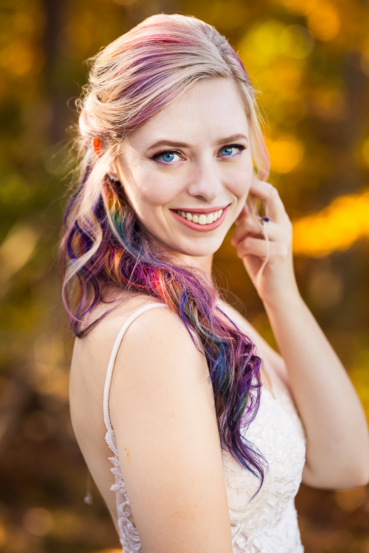 Murray Hill wedding photographer, lisa rhinehart, captures this vibrant, colorful outdoor bridal portrait of the bride showing off her colorful rainbow hair and her vibrant blue eyes