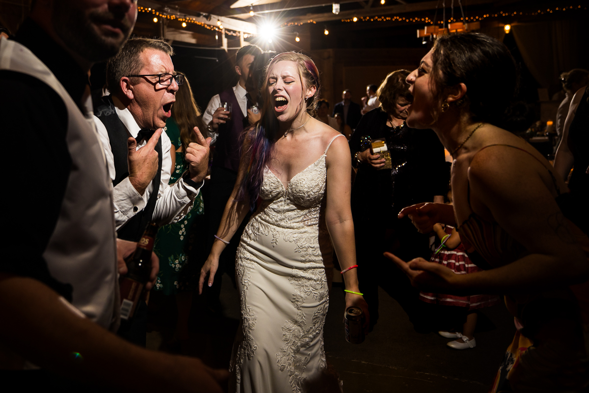 Murray Hill Wedding Photographer, lisa rhinehart, captures this fun, authentic moment of the bride with family and guests as they sing and dance during this barn wedding reception in Leesburg va 
