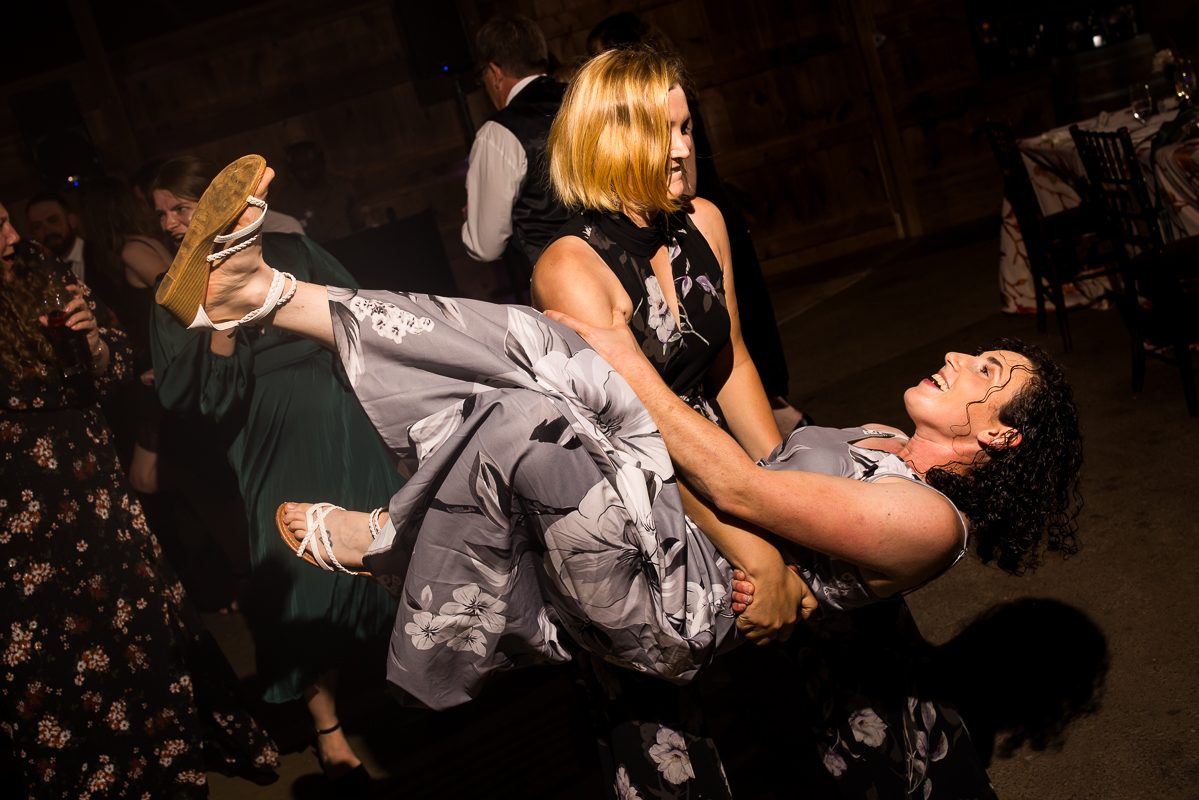 fun va wedding photographer, lisa rhinehart, captures this fun moment of guests as they dance with one another, laugh and sing during this fun barn wedding reception in Leesburg va 