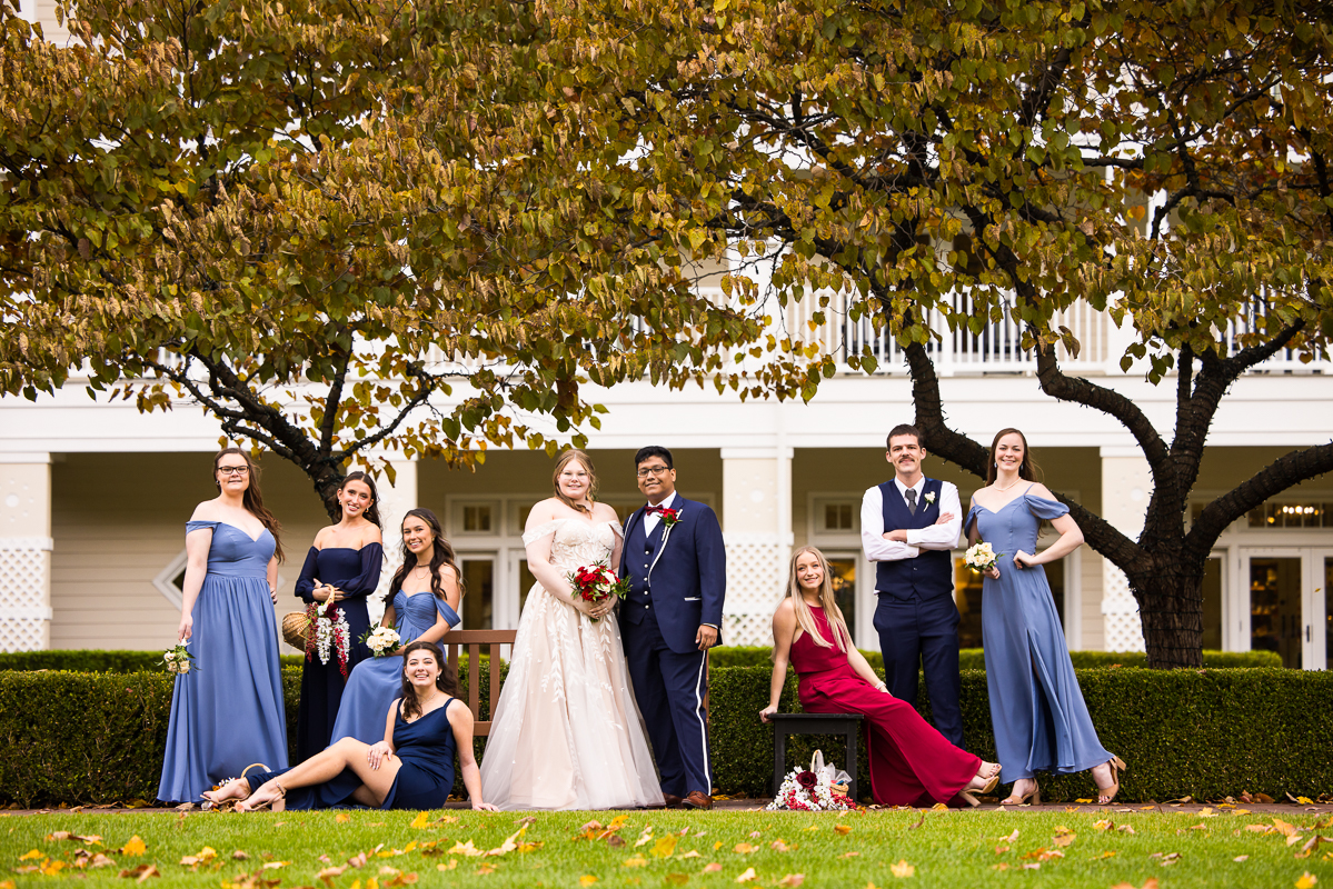 best pa wedding photographer, lisa rhinehart, captures this vogue vanity fair shot of the bride and groom with their wedding party outside of the omni bedford springs in pa before their outdoor fall wedding ceremony 