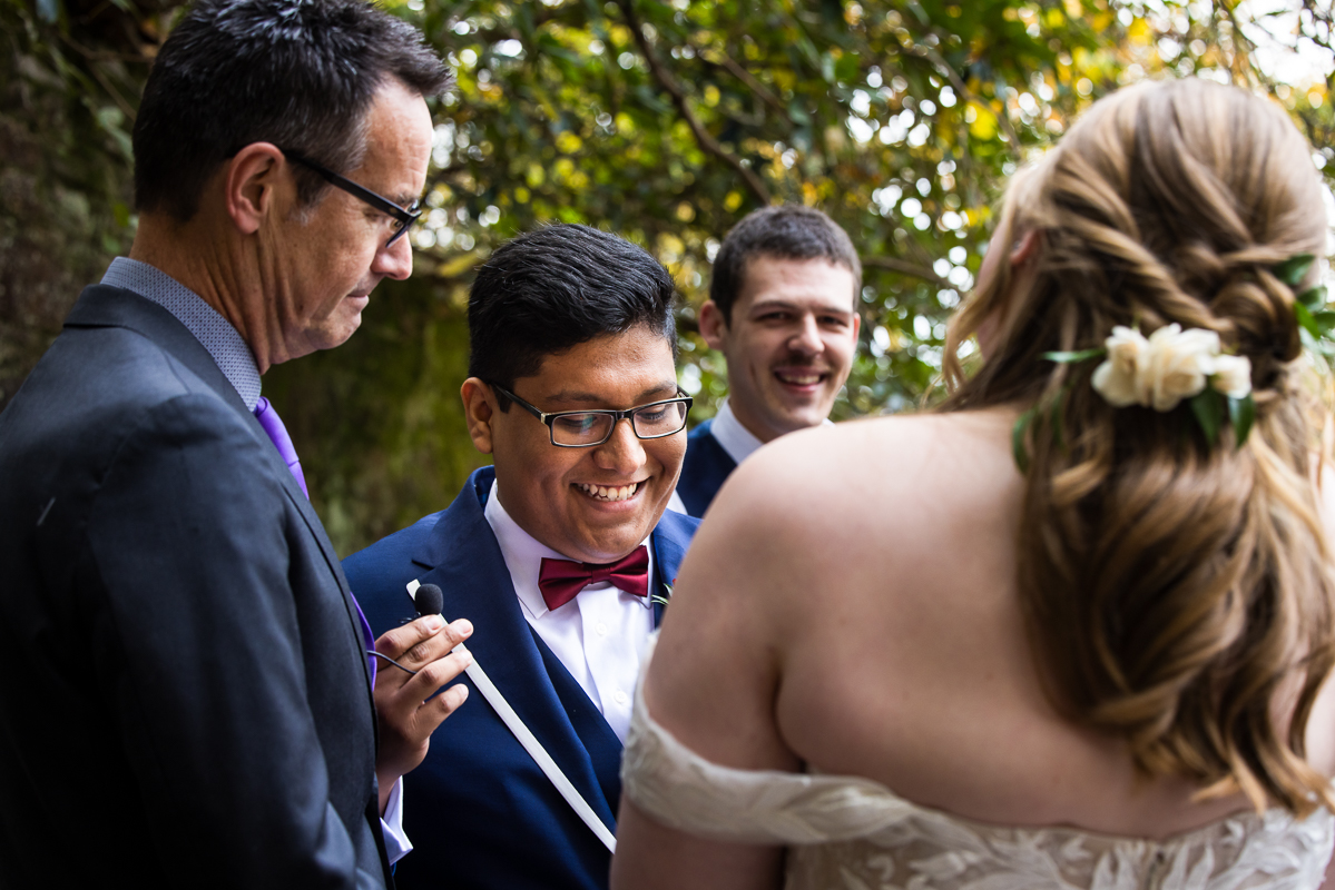close up image of the groom as he smiles and talks during this outdoor omni bedford springs wedding ceremony in Bedford pa