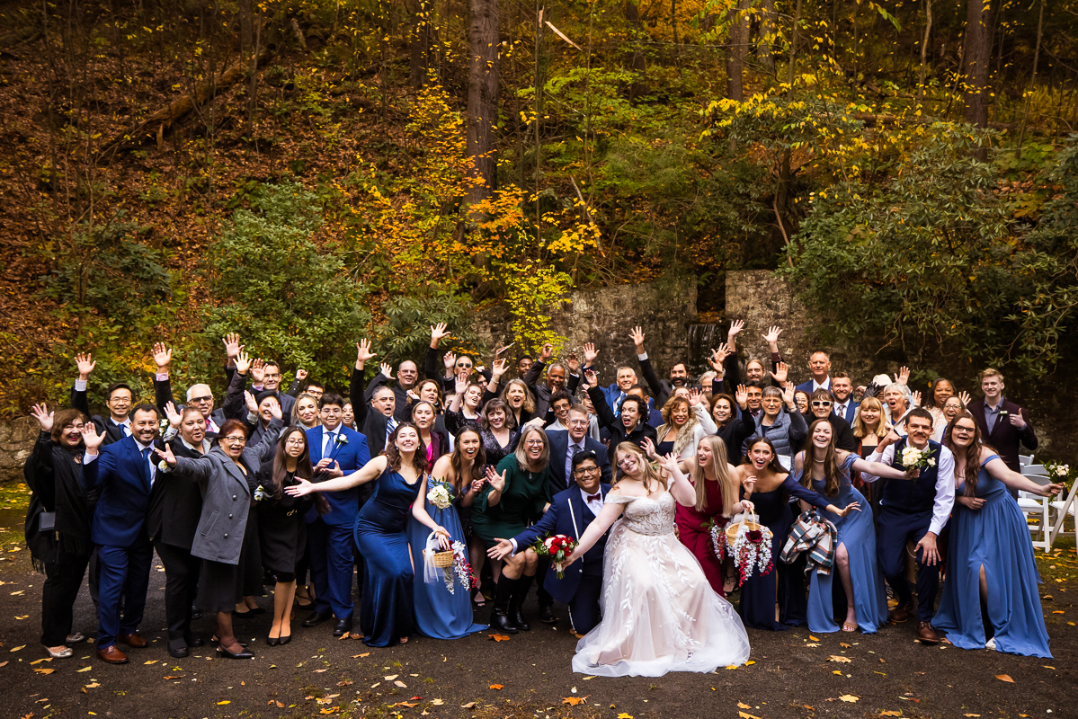 omni bedford springs wedding photographer, lisa rhinehart, captures this large group shot of the bride and groom with their wedding party, family and friends after their outdoor fall wedding at the omni bedford springs in Bedford pa 