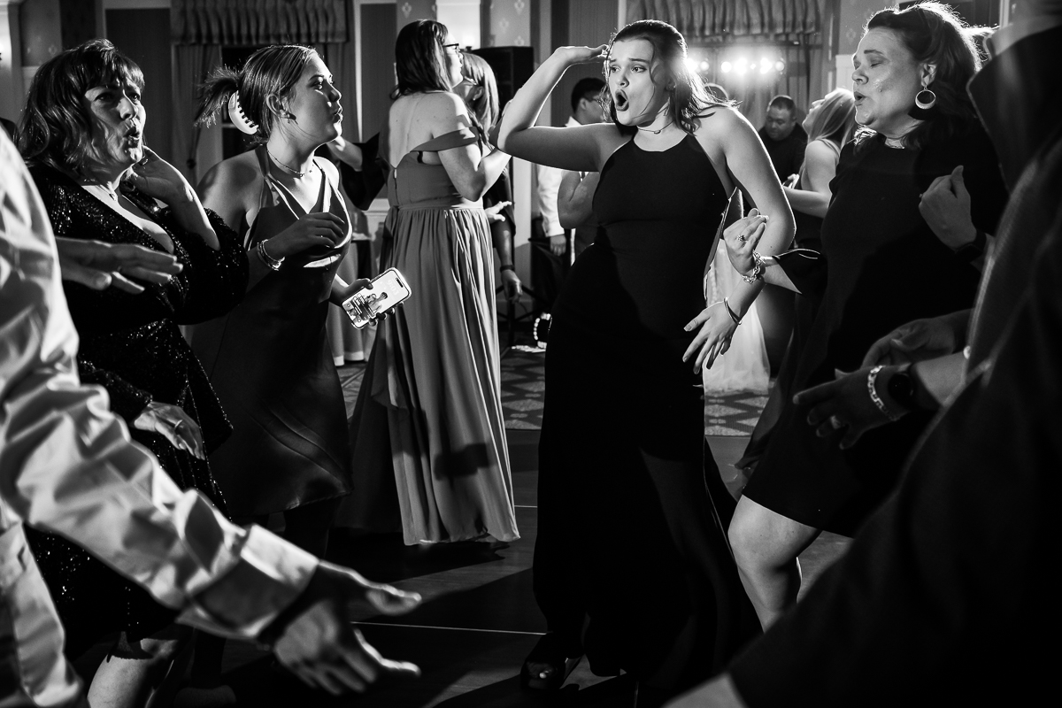 black and white image of family and friends dancing together on the dance floor during this fun pa wedding reception 