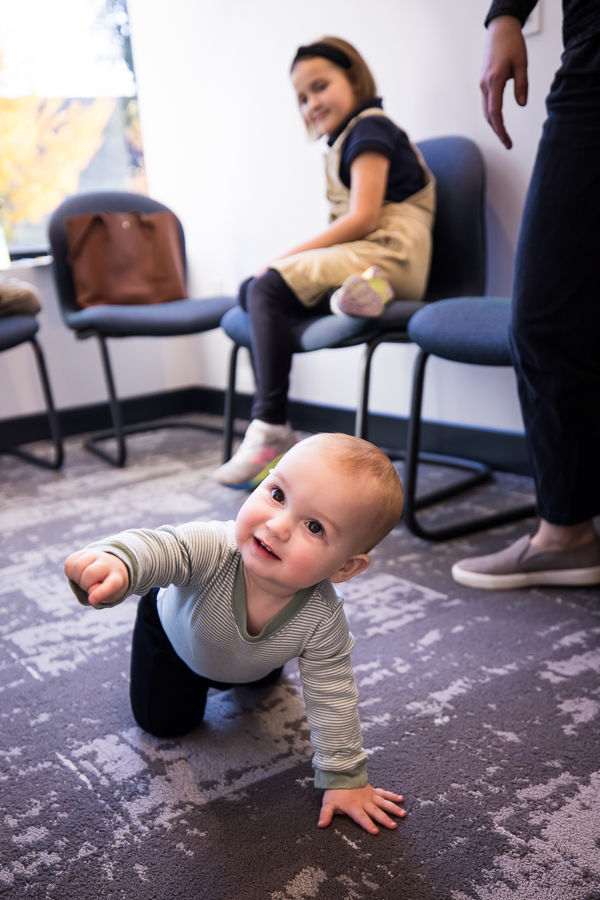 image of a baby as they crawl on the floor of the waiting room at westchester orthodontics during a business branding shoot for an orthodontist