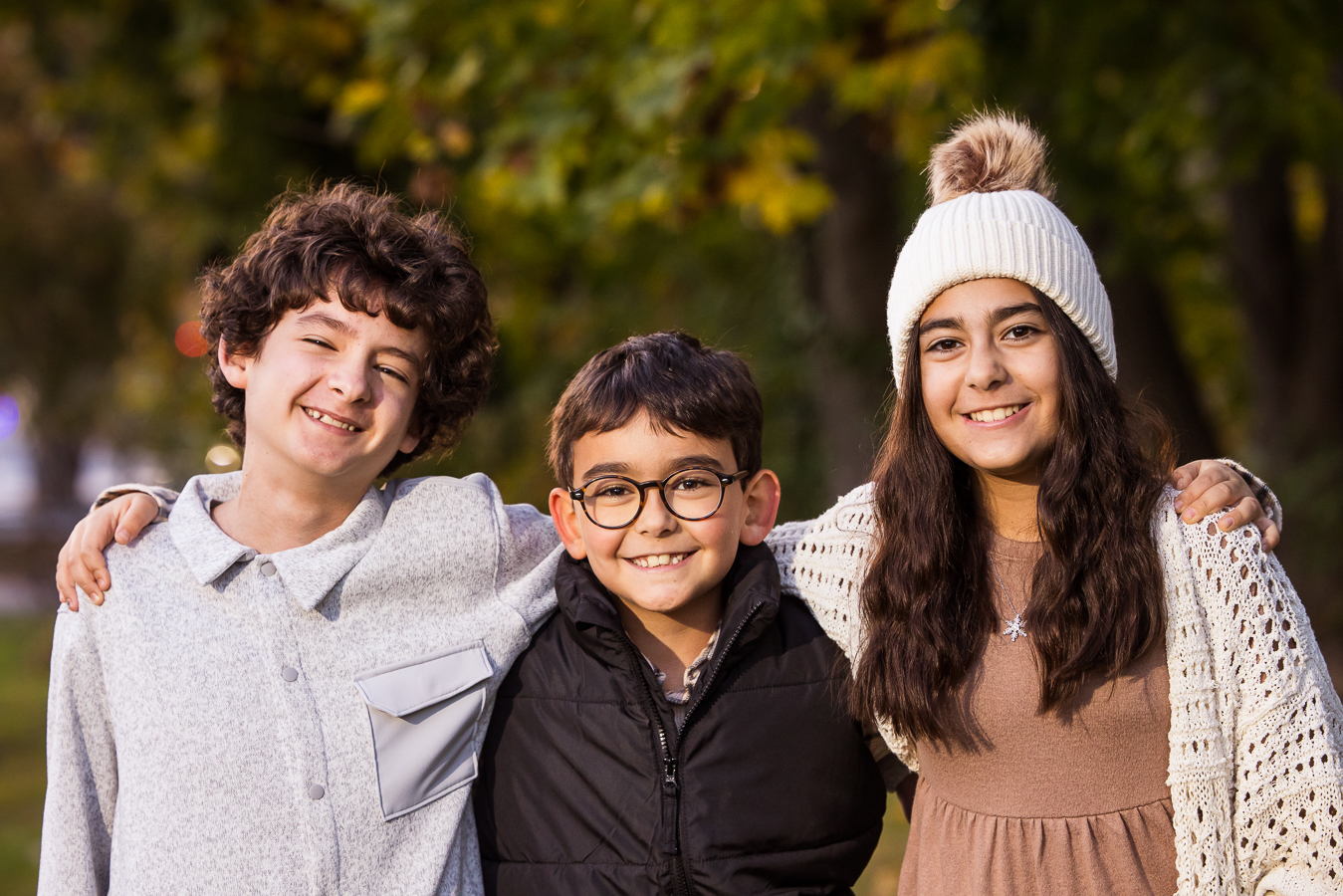 close up portrait of the three siblings standing together during this outdoor fall family portrait session in west chester pa 