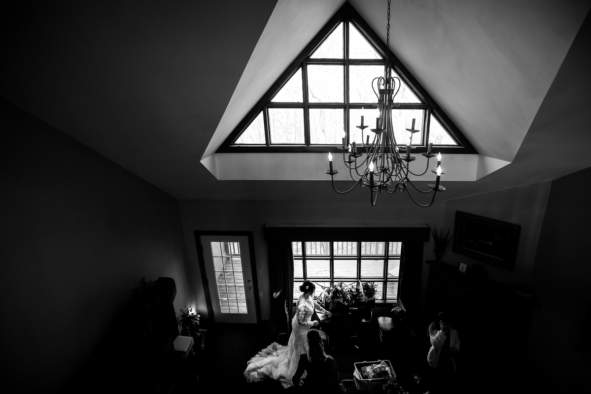 black and white image of the bride as she preps before her wedding ceremony inside of the spaces located at stroudsmoor country inn in pa 