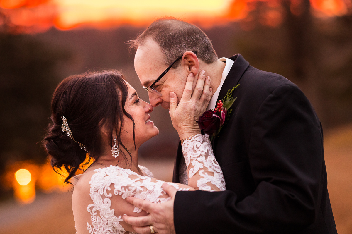 creative pa wedding photographer, lisa rhinehart, captures this vibrant, creative image of the bride and groom as they touch noses after their stroudsmoor winter wedding in pa 
