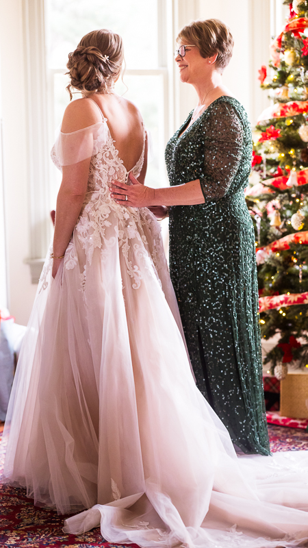 best pa wedding photographer, Lisa Rhinehart, captures the bride and her mom as they share a moment together before this Christmas wedding ceremony at stone mill inn 