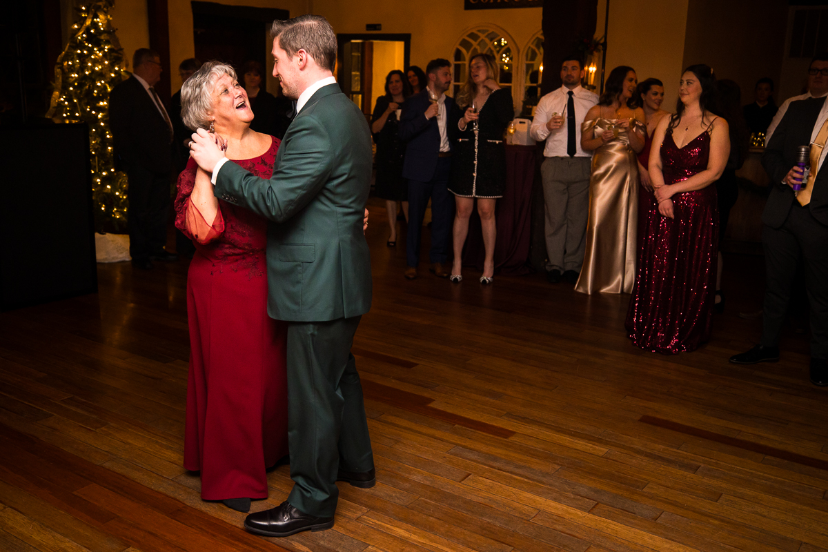 wedding photographer, Lisa Rhinehart, captures this image of the groom and his mom as they share a dance during this stone mill inn wedding reception 
