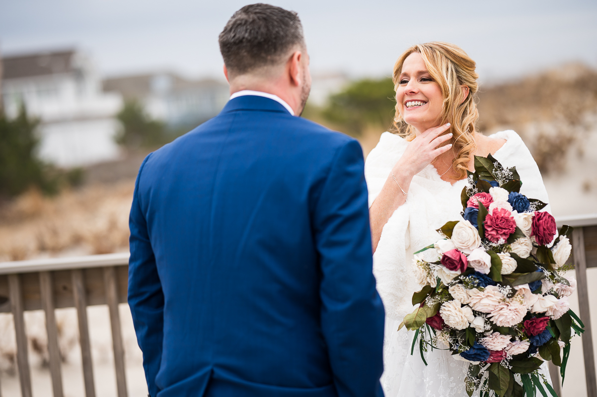 Winter Reeds Stone Harbor Wedding photographer, rhinehart photography, captures this fun, loving image of the bride and groom as they see each other for the first time during this beach, seaside first look 