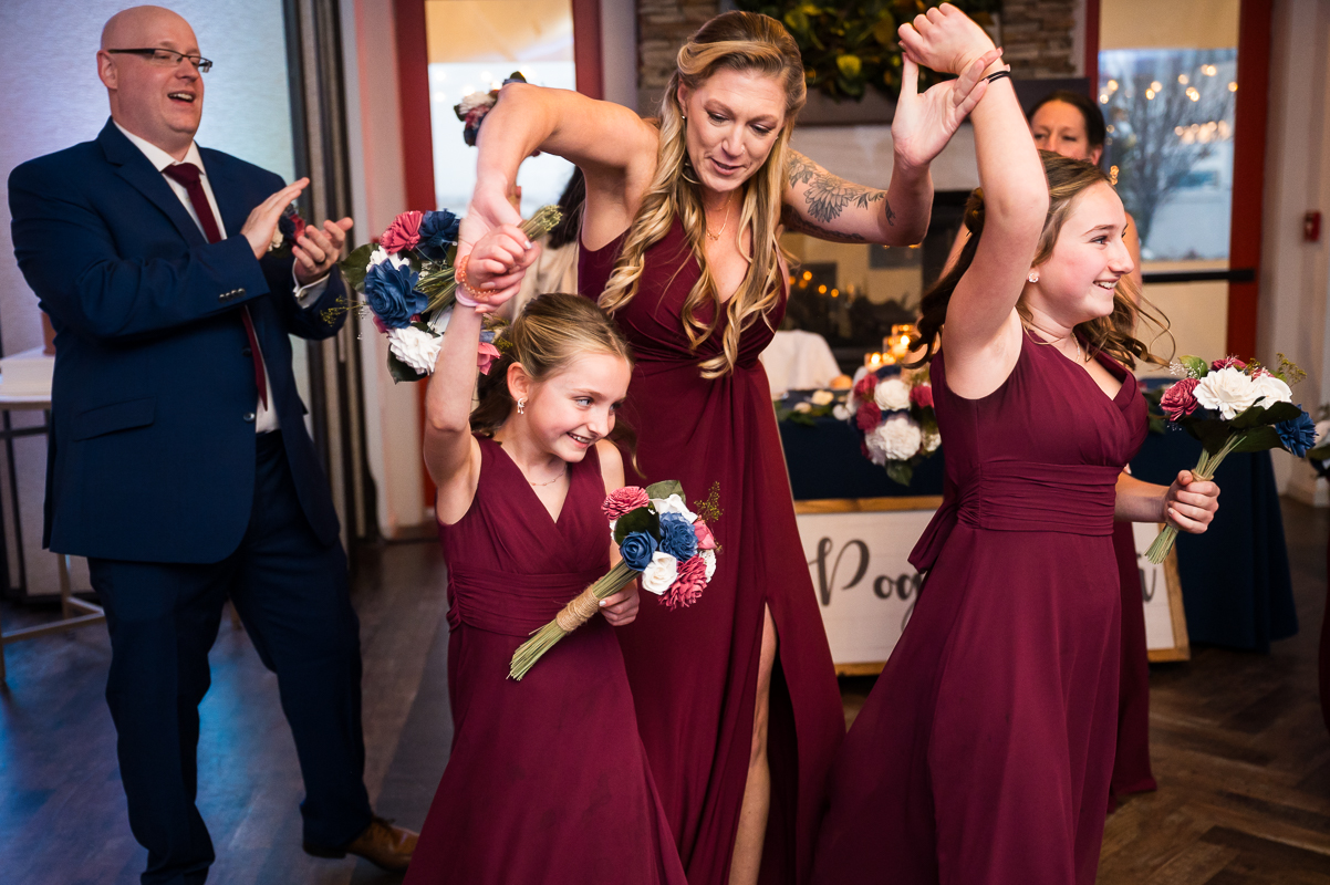 best family wedding photographer, rhinehart photography, captures this fun image of the bride and grooms kids as they enter this Winter Reeds Stone Harbor Wedding reception 